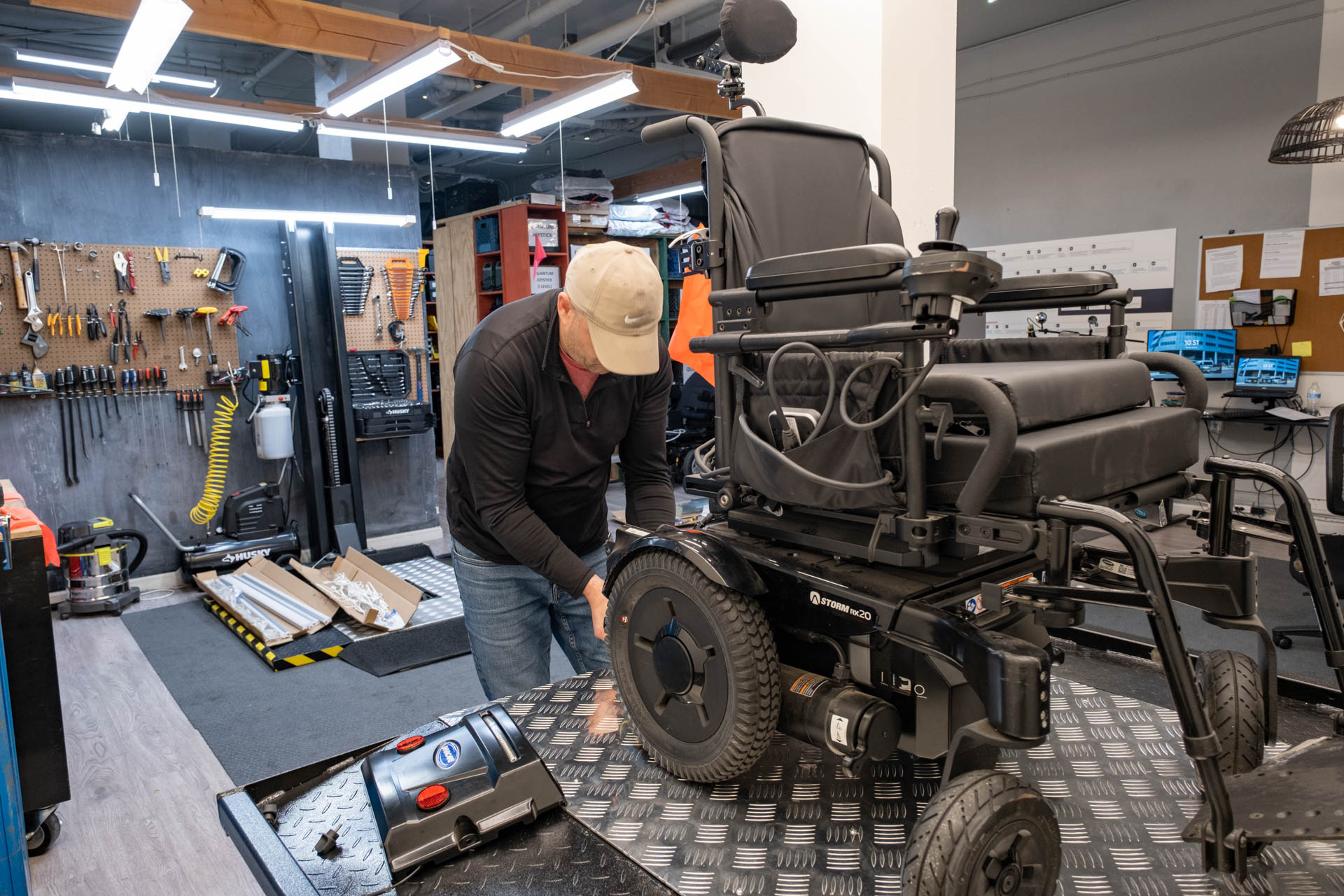 Repair Technician, Rodney removes one of the in hub motors from a clients power chair.