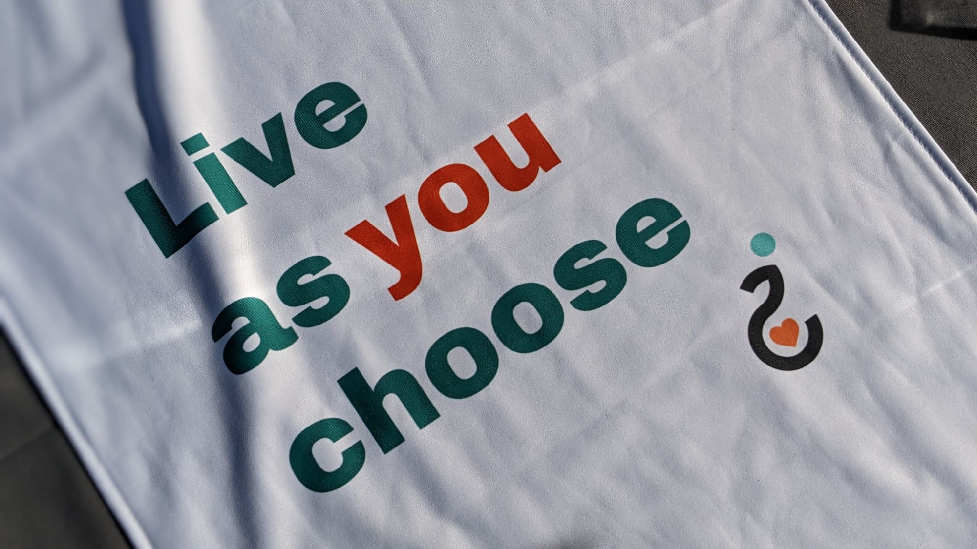 A photo of Easy Does it's table runner and Merch at an Outreach Event.