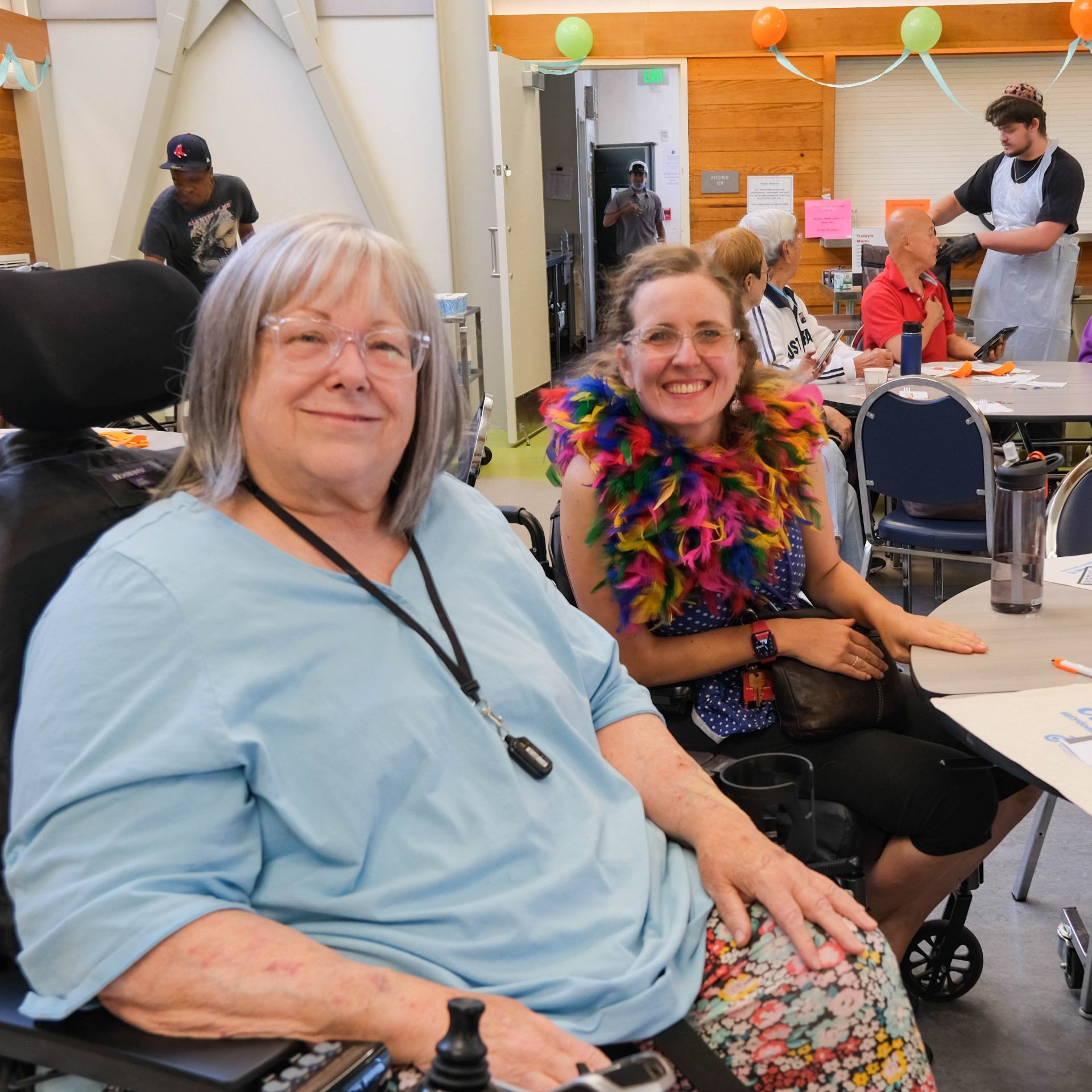 A person leaning on a chair with another person Description automatically generated