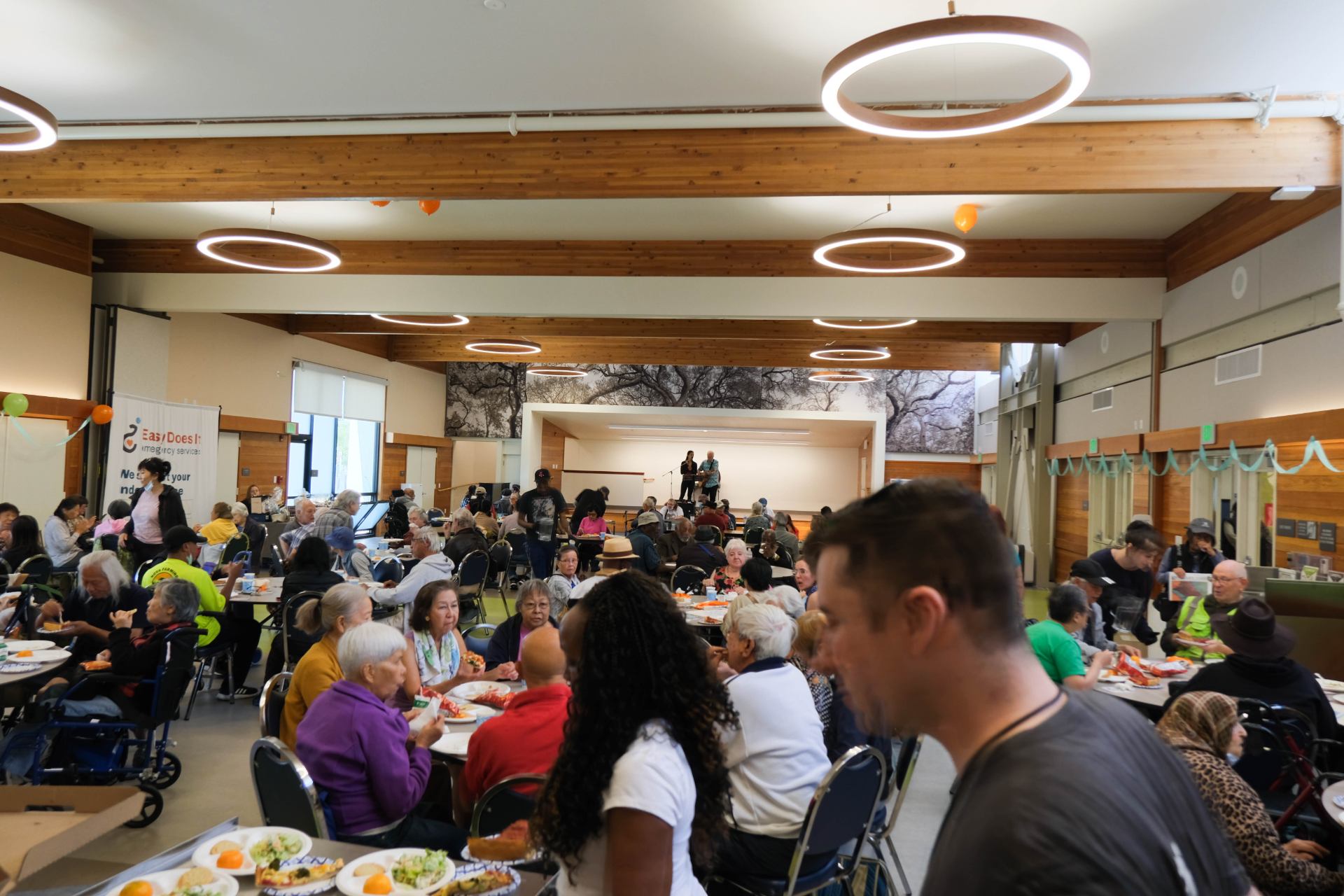 A group of people sitting at tables in a room Description automatically generated